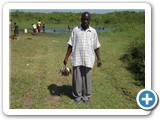 A man carrying a day's catch of stunted Nile tilapia (Oreochromis niloticus) worth Ushs 1000 (US$0.4)